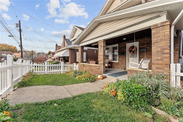 view of exterior entry featuring covered porch