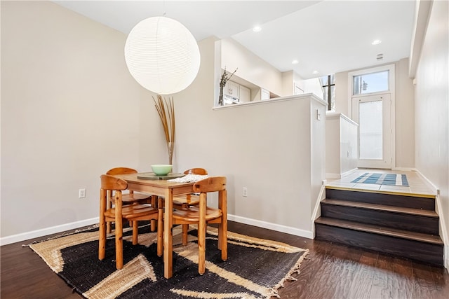 dining space with dark hardwood / wood-style flooring