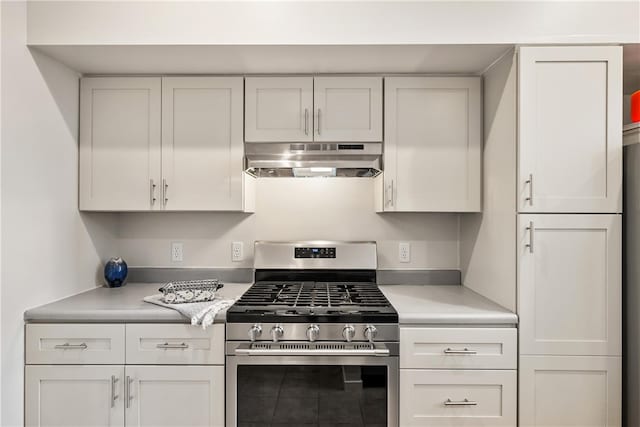 kitchen featuring stainless steel gas stove and white cabinets