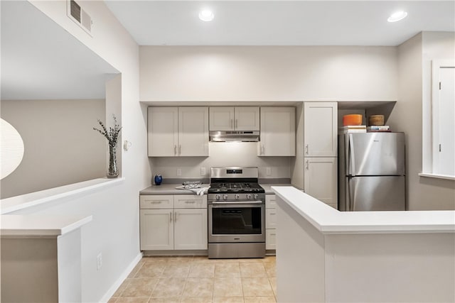 kitchen featuring stainless steel appliances and light tile patterned flooring