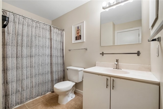 bathroom featuring vanity, tile patterned floors, and toilet