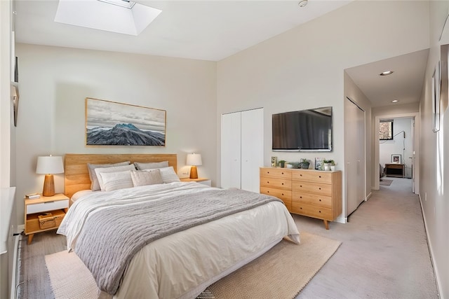 carpeted bedroom featuring a skylight