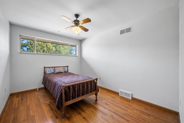 bedroom featuring hardwood / wood-style flooring and ceiling fan