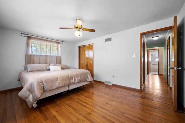 bedroom with a closet, hardwood / wood-style floors, and ceiling fan