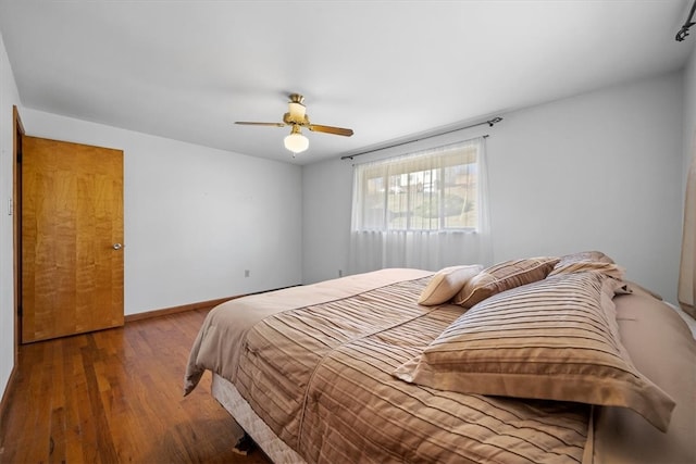 bedroom with ceiling fan and dark hardwood / wood-style floors