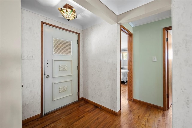 entryway featuring wood-type flooring and beam ceiling