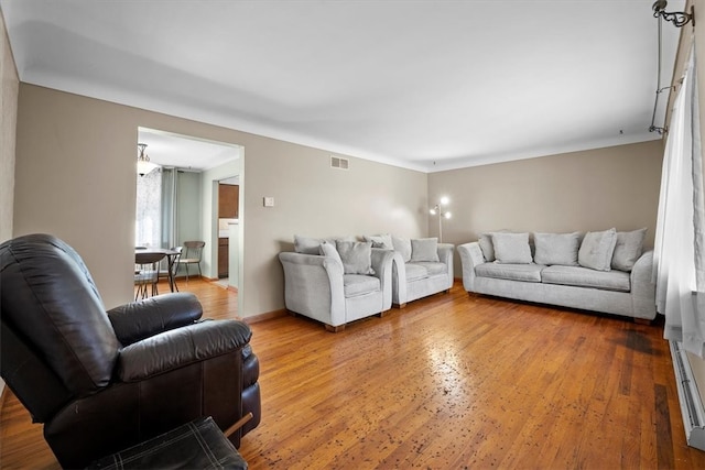 living room with hardwood / wood-style flooring and baseboard heating