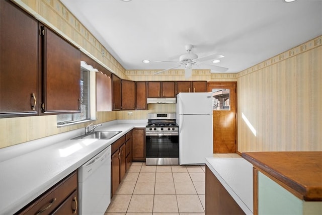 kitchen featuring light tile patterned flooring, sink, white appliances, and ceiling fan