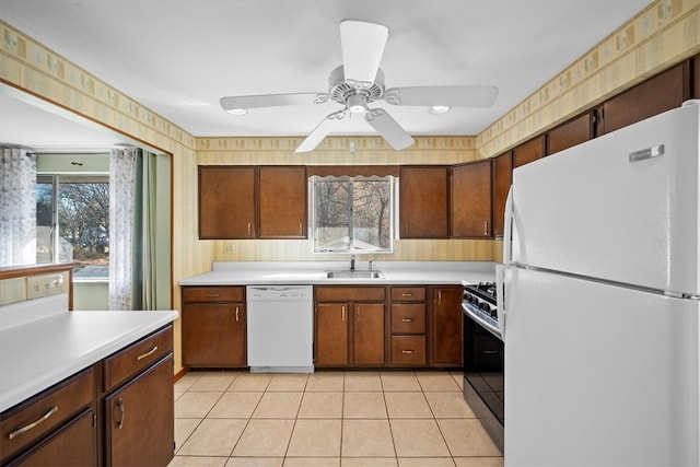 kitchen with ceiling fan, white appliances, sink, and light tile patterned flooring