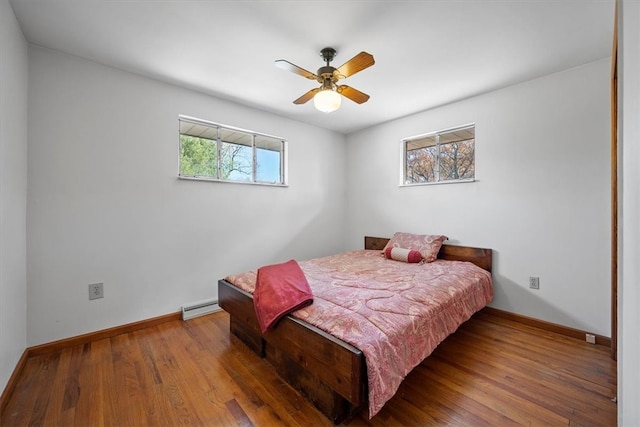 bedroom with hardwood / wood-style flooring, multiple windows, and ceiling fan