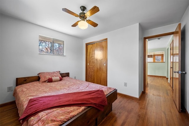 bedroom featuring ceiling fan, a closet, and wood-type flooring