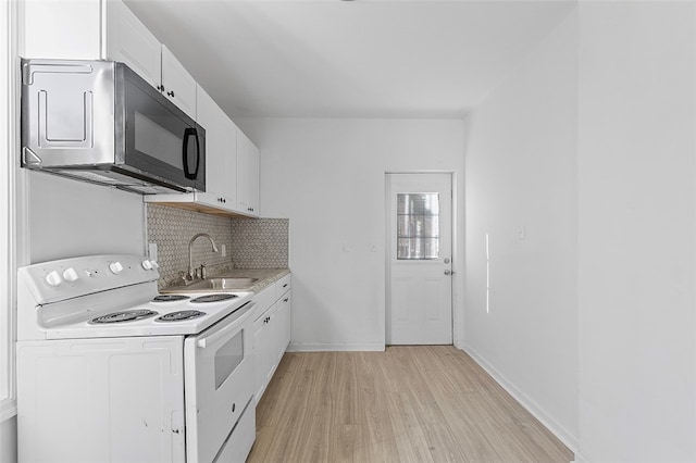 kitchen with sink, tasteful backsplash, white range with electric cooktop, white cabinets, and light wood-type flooring