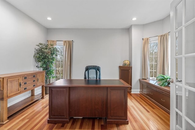 home office with light hardwood / wood-style floors