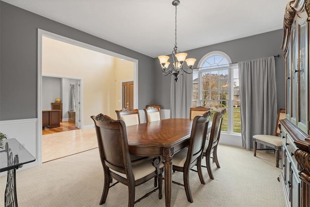 dining room featuring a chandelier and light carpet