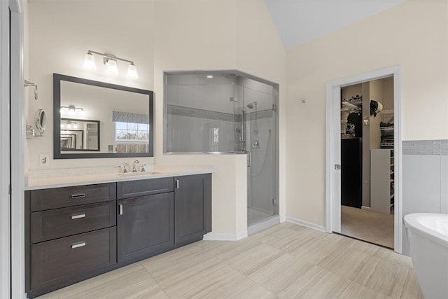 bathroom featuring lofted ceiling, separate shower and tub, and vanity