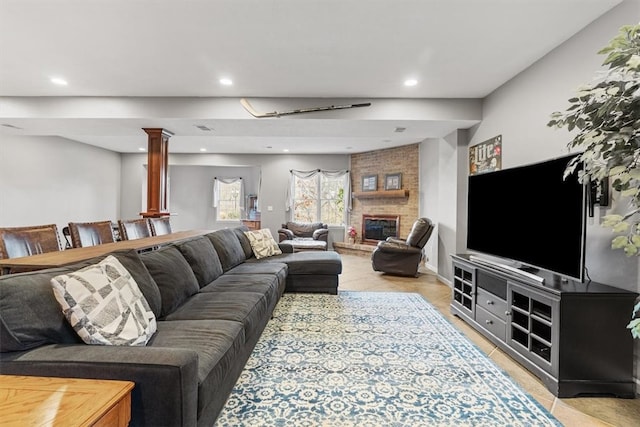 living room featuring a fireplace and decorative columns