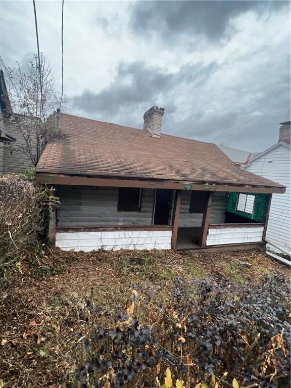 1204 Sutherland St, Sheraden, PA 15204 - back of property with a chimney
