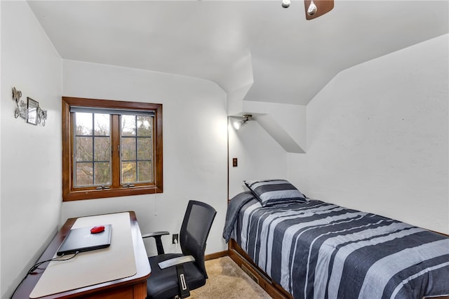 carpeted bedroom with lofted ceiling