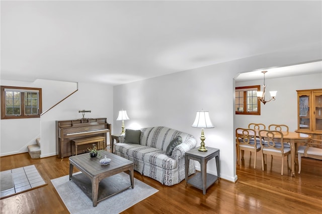 living room featuring hardwood / wood-style flooring and an inviting chandelier