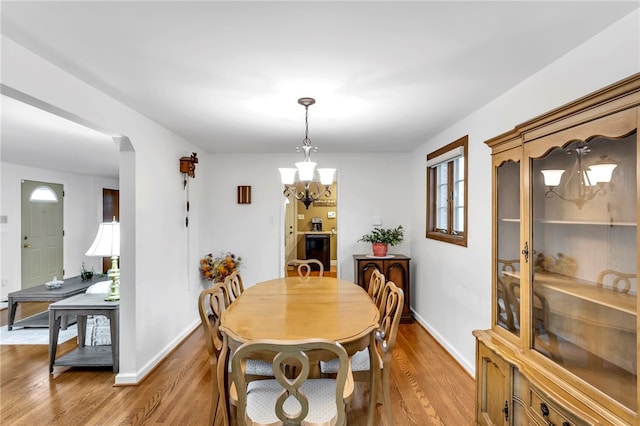 dining space featuring hardwood / wood-style floors and a notable chandelier