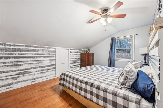 bedroom featuring ceiling fan, vaulted ceiling, and hardwood / wood-style flooring