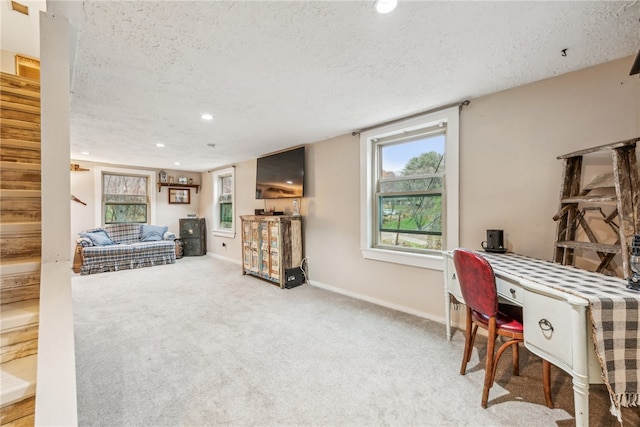 home office featuring carpet and a textured ceiling