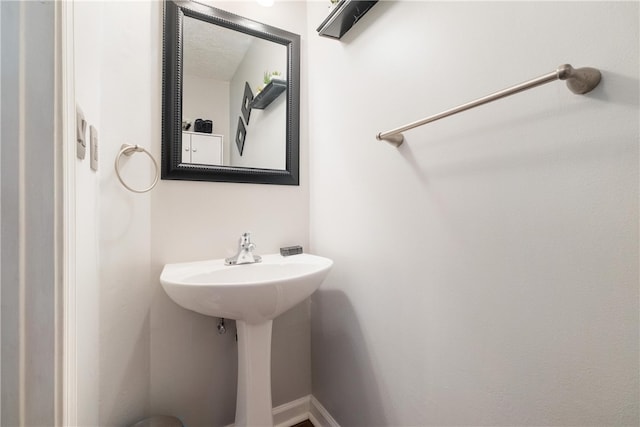 bathroom with a textured ceiling and sink