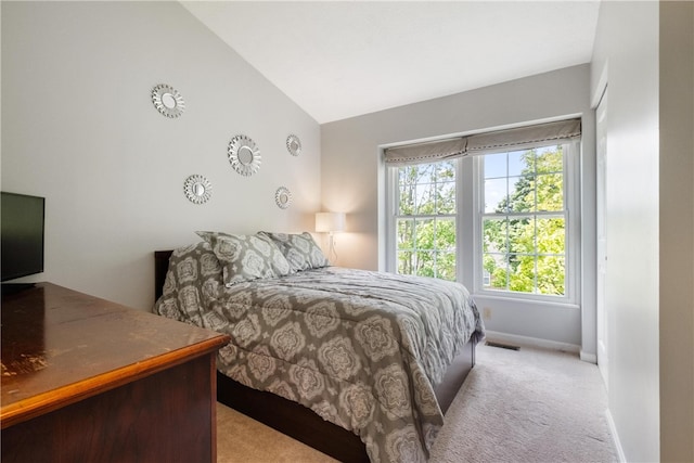 carpeted bedroom featuring lofted ceiling