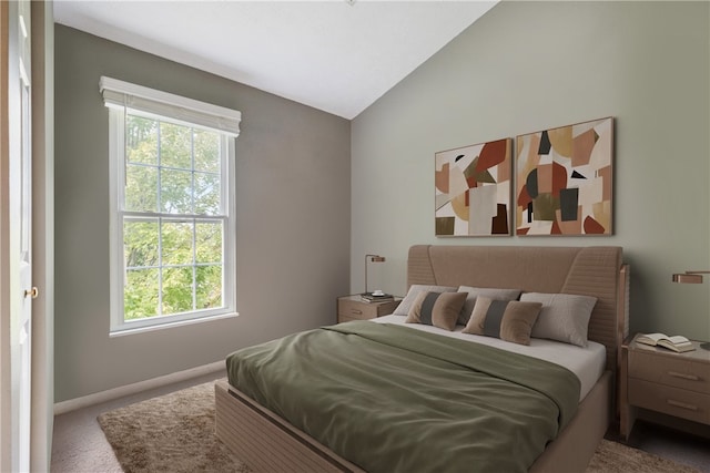 bedroom featuring vaulted ceiling and carpet floors