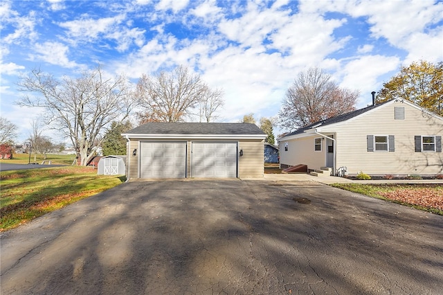 exterior space with a garage and a storage unit