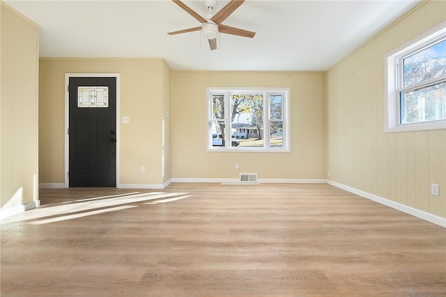 foyer entrance featuring ornamental molding, light hardwood / wood-style floors, and ceiling fan