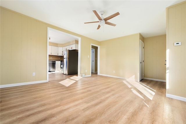 unfurnished living room featuring ceiling fan, light hardwood / wood-style floors, and crown molding