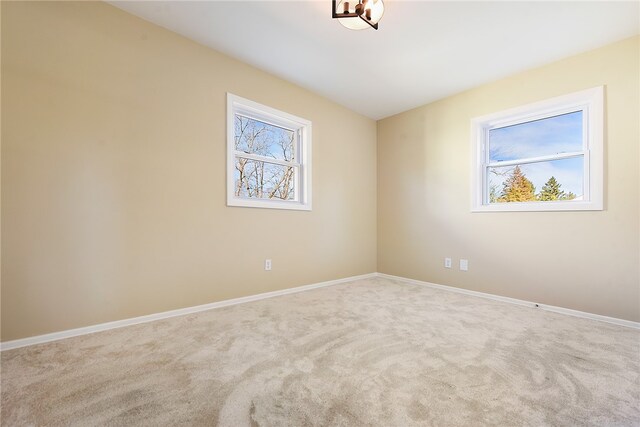 carpeted empty room featuring a healthy amount of sunlight