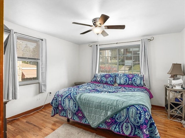 bedroom featuring hardwood / wood-style floors and ceiling fan