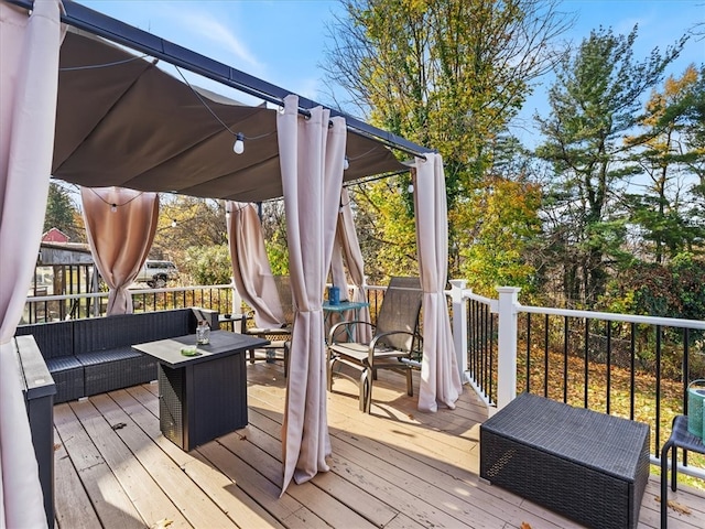 wooden terrace with an outdoor hangout area