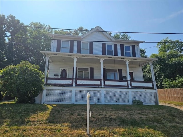 view of front of home with a porch and a front lawn