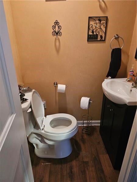 bathroom featuring hardwood / wood-style floors, vanity, and toilet