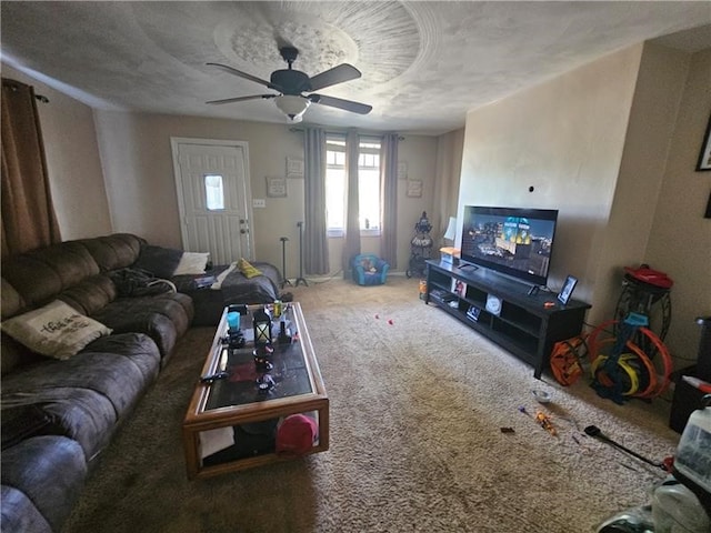 carpeted living room with ceiling fan and a textured ceiling