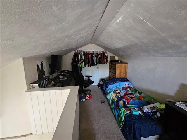 bedroom featuring vaulted ceiling, carpet floors, and a textured ceiling