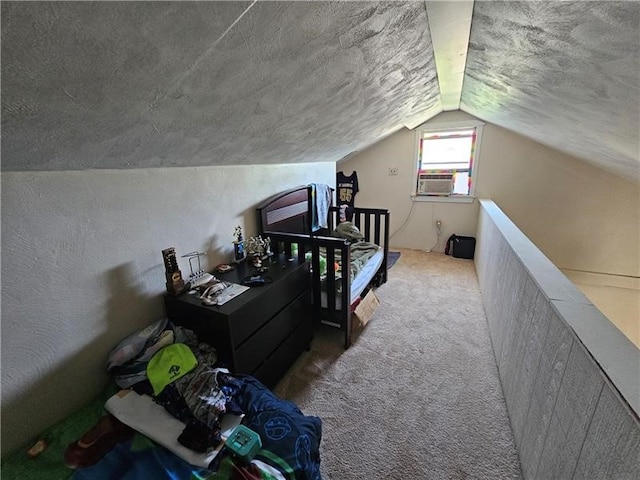 bedroom featuring carpet floors, a textured ceiling, and lofted ceiling