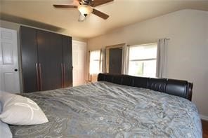 bedroom with ceiling fan and a closet