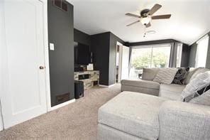 carpeted living room featuring ceiling fan and lofted ceiling