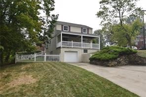 view of front of home with a garage and a front yard