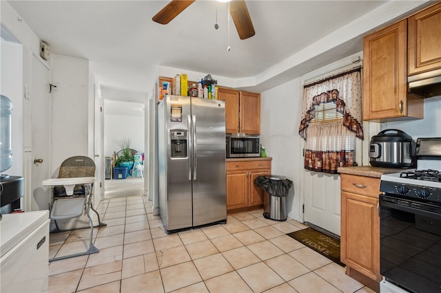 kitchen with ventilation hood, ceiling fan, light tile patterned floors, and appliances with stainless steel finishes