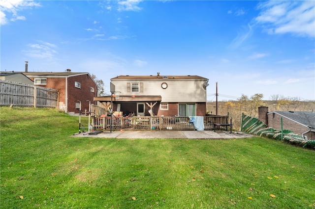 back of house with a patio and a lawn