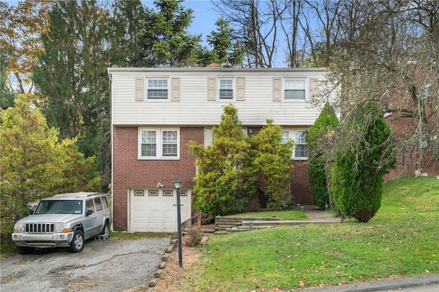 view of front of property featuring a garage and a front yard