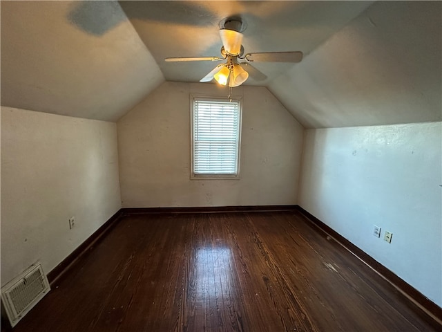 bonus room with ceiling fan, dark wood-type flooring, and vaulted ceiling