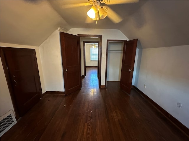 additional living space featuring dark hardwood / wood-style flooring, ceiling fan, and lofted ceiling