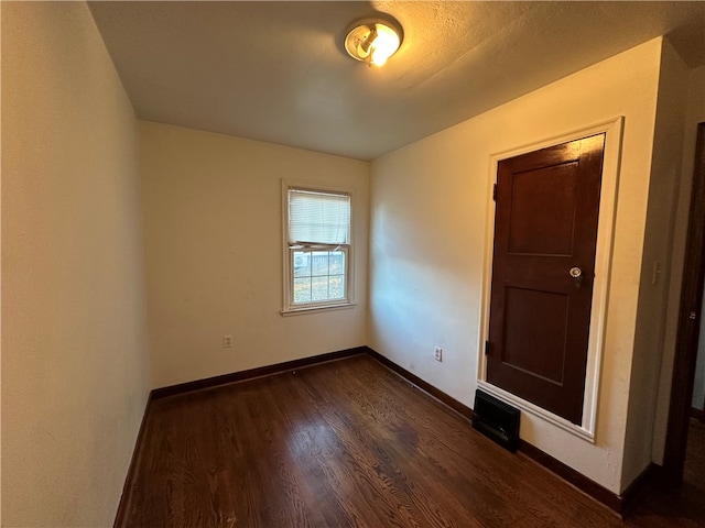 unfurnished room featuring dark hardwood / wood-style floors