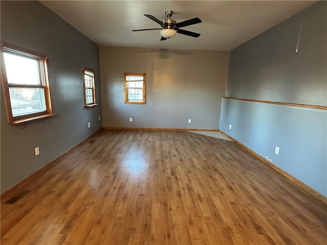 spare room with ceiling fan and light wood-type flooring